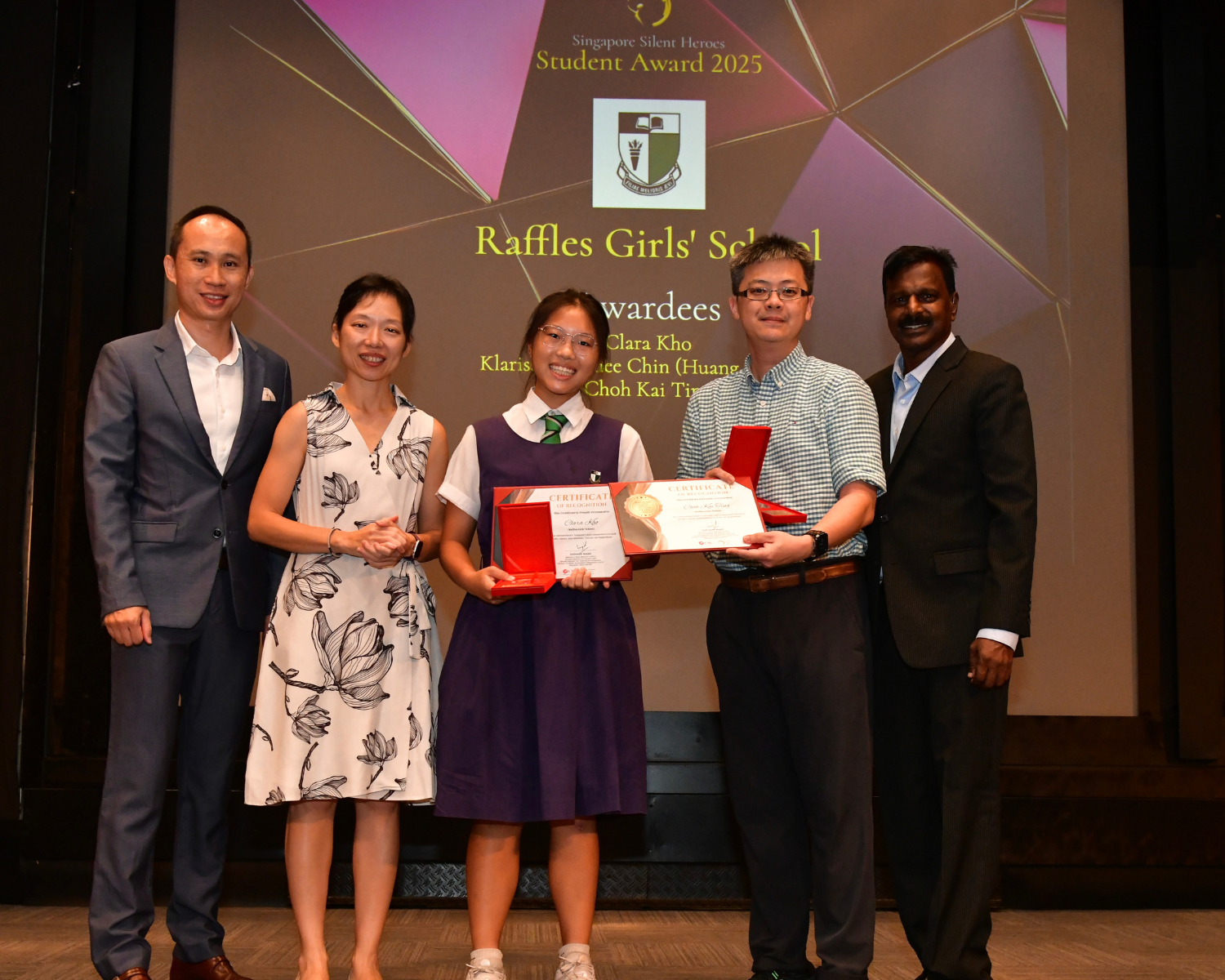 Singapore Silent Heroes. RGS student posing with GOH and receiving award